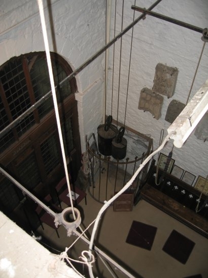 Clock weights before winding inside tower