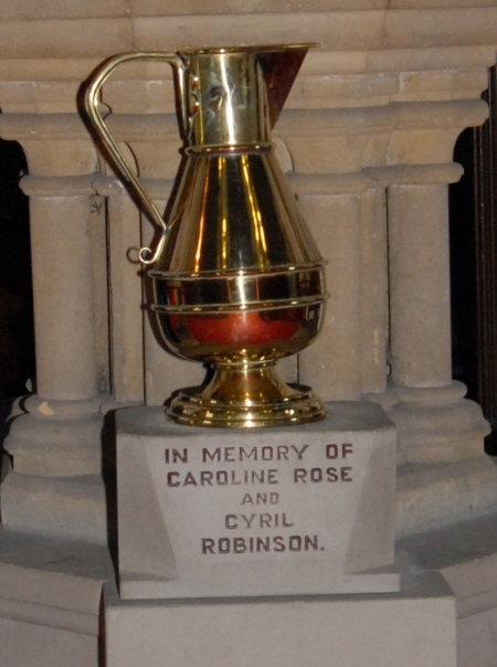 Memorial vase in front of the Edwardian font
