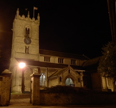 Church floodlit from gateway